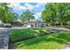 Charming single-story home with lush green lawn, mature trees, and a circular driveway at 3910 W Comanche Ave, Tampa, FL 33614