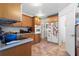 Well-lit kitchen with a stove top, built in oven, and ample counter space at 3910 W Comanche Ave, Tampa, FL 33614