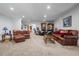 Open-concept living room with comfortable seating, neutral tones, and seamless transition to other spaces at 3910 W Comanche Ave, Tampa, FL 33614