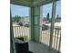 Balcony with seating and a view of the parking and other buildings at 400 64Th Ave # 202, St Pete Beach, FL 33706