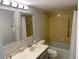 Clean bathroom features a bathtub, shower, and a double vanity with mirrors at 400 64Th Ave # 202, St Pete Beach, FL 33706
