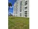 Waterfront condo building featuring multiple balconies and lush green lawn at 400 64Th Ave # 202, St Pete Beach, FL 33706