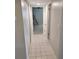 Hallway leading to bedroom with tile flooring at 400 64Th Ave # 202, St Pete Beach, FL 33706