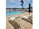 Community pool featuring lounge chairs, umbrellas, and beautiful waterfront views at 400 64Th Ave # 202, St Pete Beach, FL 33706