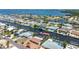 Aerial view of the waterfront community with canal access, featuring homes with pools and boat docks on a sunny day at 4011 99Th W St, Bradenton, FL 34210