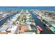 Aerial view showcases canal-front homes, manicured lawns, boat docks, and palm-lined streets in a coastal community at 4011 99Th W St, Bradenton, FL 34210