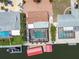 Aerial view showcases backyard pool, boat dock, and paver driveway, highlighting outdoor living spaces at 4011 99Th W St, Bradenton, FL 34210