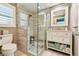 This bathroom features a glass enclosed shower, a pebble floor, and a modern vanity with ample storage at 4011 99Th W St, Bradenton, FL 34210