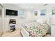 Bright bedroom with white furniture, beach themed quilt, and mounted television at 4011 99Th W St, Bradenton, FL 34210