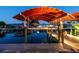 Covered boat lift at dusk, providing protection for your boat on the waterfront property at 4011 99Th W St, Bradenton, FL 34210