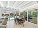 Dining room with a long table, seating for six, and sliding glass doors leading to the pool and patio at 4011 99Th W St, Bradenton, FL 34210