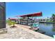 Modern boat dock with covered boat lift provides convenient access to waterfront activities at 4011 99Th W St, Bradenton, FL 34210