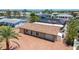 Aerial view showcasing the home with a tile roof, paver driveway, and attached garage amid lush surroundings at 4011 99Th W St, Bradenton, FL 34210