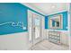 Bright foyer with a white door, coastal decor, white wainscoting, and light tile flooring at 4011 99Th W St, Bradenton, FL 34210