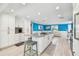Bright and airy kitchen with white cabinets, a center island, and views into the living room at 4011 99Th W St, Bradenton, FL 34210