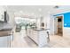 Well-designed kitchen with white cabinets, a center island, and views of the outdoor living space at 4011 99Th W St, Bradenton, FL 34210
