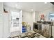 Well-organized laundry room with stainless steel appliances, white cabinets, and a view into the kitchen at 4011 99Th W St, Bradenton, FL 34210
