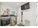 Efficient laundry area with modern appliances, wall-mounted TV, and ample storage solutions at 4011 99Th W St, Bradenton, FL 34210