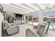 Living room with recliner seating and a bar, next to sliding glass doors leading to the outdoor pool area at 4011 99Th W St, Bradenton, FL 34210
