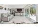 A view of the living room, with lounge seating and a bar, featuring direct access to the pool area at 4011 99Th W St, Bradenton, FL 34210