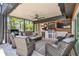 A covered lanai features an outdoor kitchen, ceiling fan, and comfortable seating for relaxing and enjoying the Florida lifestyle at 4011 99Th W St, Bradenton, FL 34210