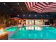 A lovely swimming pool and spa with underwater lighting, surrounded by lounge seating and a partially screened lanai at 4011 99Th W St, Bradenton, FL 34210