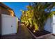 The side yard with beautiful tropical landscaping features decorative pathway lighting, offering a calm aesthetic at 4011 99Th W St, Bradenton, FL 34210