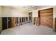 Bedroom during renovation with exposed framing, a ceiling fan, and wood paneling at 4144 Hampton Dr # C, New Port Richey, FL 34652