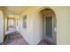 Covered porch with arched entryways, brick floor and front door at 4144 Hampton Dr # C, New Port Richey, FL 34652
