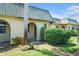 Charming villa featuring arched entryways, verdant landscaping, and a metal roof at 4144 Hampton Dr # C, New Port Richey, FL 34652