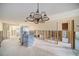 Large living room with chandelier under construction with open stud walls at 4144 Hampton Dr # C, New Port Richey, FL 34652