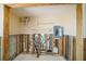 Utility room undergoing renovation with exposed framing, electrical panel, and plumbing features at 4144 Hampton Dr # C, New Port Richey, FL 34652