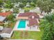 Aerial view of the home features a backyard pool, an outdoor lounge area, and a brown shingle roof at 4500 22Nd N Ave, St Petersburg, FL 33713