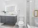 Renovated bathroom features a LED mirror, modern vanity, and glass enclosed shower at 4500 22Nd N Ave, St Petersburg, FL 33713