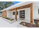 Inviting front porch with wood columns, modern front door, and lush landscaping at 4500 22Nd N Ave, St Petersburg, FL 33713