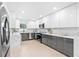 Modern kitchen with sleek white and gray cabinets, stainless steel appliances, and elegant marble countertops at 4500 22Nd N Ave, St Petersburg, FL 33713