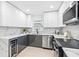 Updated kitchen with modern stainless steel appliances and white and gray cabinets for an elegant feel at 4500 22Nd N Ave, St Petersburg, FL 33713