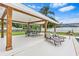 Backyard featuring a covered patio with outdoor seating, overlooking a manicured lawn and landscaping at 4500 22Nd N Ave, St Petersburg, FL 33713