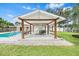 Backyard oasis with a covered patio, lounge chairs, outdoor seating, and a sparkling pool at 4500 22Nd N Ave, St Petersburg, FL 33713