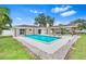Expansive backyard featuring a refreshing swimming pool, covered patio, and lush green surroundings at 4500 22Nd N Ave, St Petersburg, FL 33713