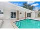Covered patio with a swimming pool and tiled stairs in a serene backyard setting with white brick columns at 4500 22Nd N Ave, St Petersburg, FL 33713