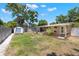 Spacious backyard with mature trees, shed, landscaping and a screened-in porch at 4519 S Grady Ave, Tampa, FL 33611