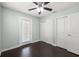 Bright bedroom with hardwood floors, a ceiling fan, access to the outside, and closet at 4519 S Grady Ave, Tampa, FL 33611