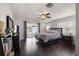 This bedroom features a sliding glass door, a ceiling fan, and hardwood floors at 4519 S Grady Ave, Tampa, FL 33611