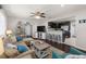 Open-concept living room with hardwood floors, opening to a modern kitchen with stainless steel appliances at 4519 S Grady Ave, Tampa, FL 33611