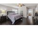 Serene main bedroom with dark wood floors, a ceiling fan, and a relaxing view to dining room at 4519 S Grady Ave, Tampa, FL 33611