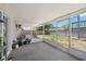 Screened-in porch features an outdoor seating area and views of the expansive backyard at 4519 S Grady Ave, Tampa, FL 33611