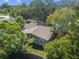 Backyard aerial view featuring mature trees and a fenced yard providing privacy and shade at 503 Tangerine Dr, Oldsmar, FL 34677