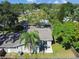 Aerial view of a fenced backyard featuring a patio and mature trees providing shade and privacy at 503 Tangerine Dr, Oldsmar, FL 34677