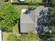 Overhead view of home's backyard, showcasing the roof, mature trees, patio and fenced yard at 503 Tangerine Dr, Oldsmar, FL 34677